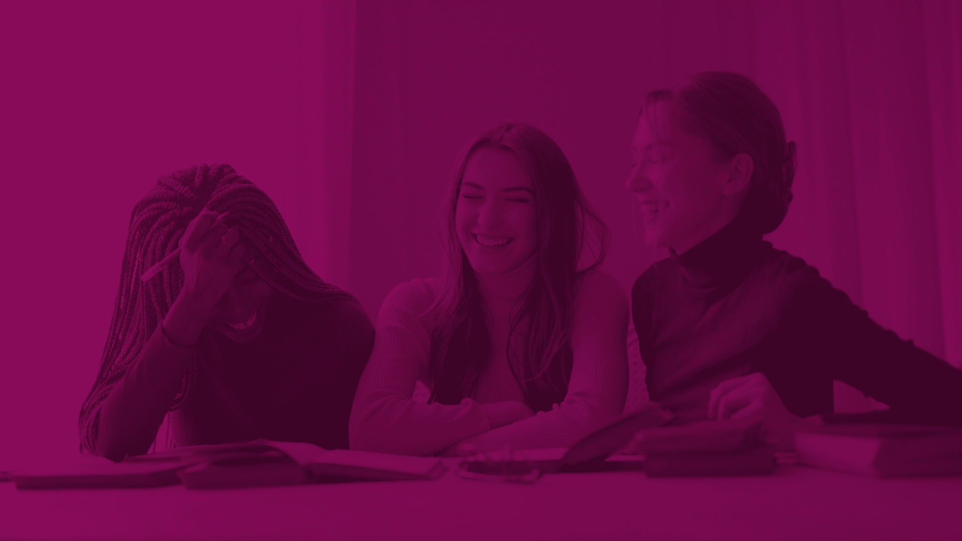 Women laughing at a table
