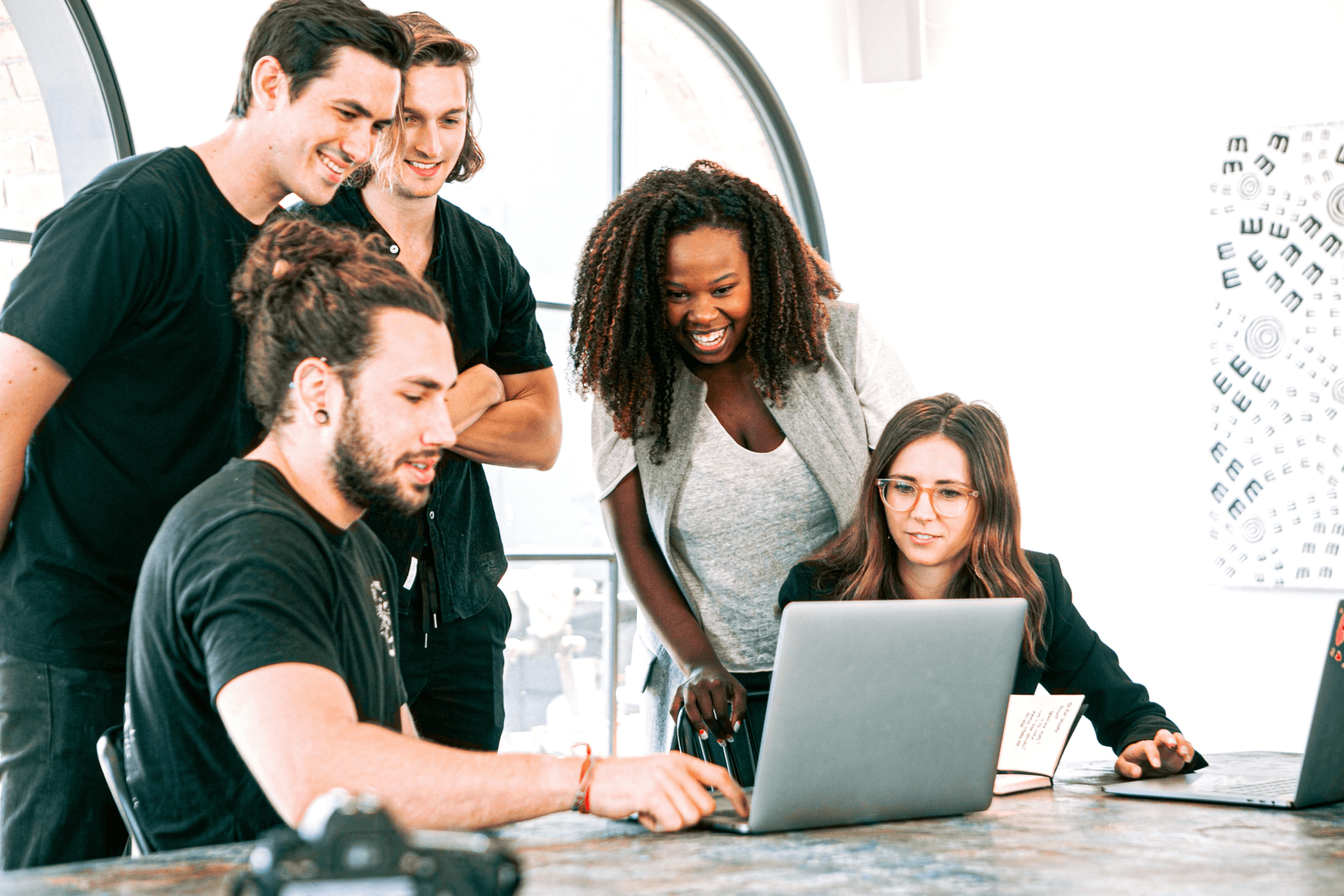 People in a meeting looking at a laptop screen